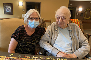 Candy Eckert. An RN at Auburn homes and Services with a resident.