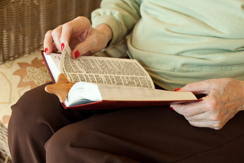 Auburn Homes resident reading Bible